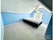 Attic bedroom with blue walls, gray carpeting, a ceiling fan, and natural light at 2025 Sojourn Rd, Marshville, NC 28103