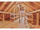 An unfinished attic featuring exposed wood beams, wood floor, and storage space at 2025 Sojourn Rd, Marshville, NC 28103