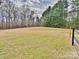 Expansive backyard featuring an open field bordered by mature trees, and a partial fence adding privacy at 2025 Sojourn Rd, Marshville, NC 28103