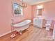 Elegant pink bathroom featuring a clawfoot tub, chandelier, and stylish vanity at 2025 Sojourn Rd, Marshville, NC 28103