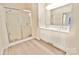 Spacious bathroom featuring double sinks, a glass-enclosed shower, and modern design at 2025 Sojourn Rd, Marshville, NC 28103