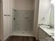 Beautiful bathroom featuring walk-in shower with marble-look tile and double sink vanity with marble countertops at 2025 Sojourn Rd, Marshville, NC 28103
