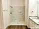 Modern bathroom featuring a new tile shower, new floors, and updated vanity at 2025 Sojourn Rd, Marshville, NC 28103