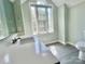 Bright, freshly painted bathroom with a large window, toilet, and single vanity sink at 2025 Sojourn Rd, Marshville, NC 28103