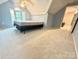 Slanted ceiling bedroom with a window, ceiling fan and attached full bath at 2025 Sojourn Rd, Marshville, NC 28103