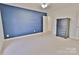 A bedroom with a navy blue wall, neutral carpet and a dark wood dresser at 2025 Sojourn Rd, Marshville, NC 28103