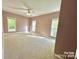 Spacious carpeted bedroom features a ceiling fan and an abundance of natural light from three large windows at 2025 Sojourn Rd, Marshville, NC 28103