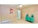 Bedroom with carpeted floors, painting of Disney princesses, turquoise accent table, and access door to hall at 2025 Sojourn Rd, Marshville, NC 28103