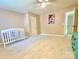 Spacious bedroom with a ceiling fan, neutral walls, and a baby crib in the corner at 2025 Sojourn Rd, Marshville, NC 28103