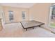 Bright bedroom featuring neutral walls, plush carpet, and natural light from large windows at 2025 Sojourn Rd, Marshville, NC 28103