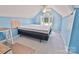 An attic bedroom featuring a blue-painted vaulted ceiling, a window, and carpeted floors at 2025 Sojourn Rd, Marshville, NC 28103