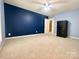 Spacious bedroom with carpeted floors, two toned paint, ceiling fan, and access door to bathroom at 2025 Sojourn Rd, Marshville, NC 28103