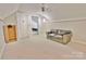 A bonus room with carpet flooring, a ceiling fan and an olive-green sofa at 2025 Sojourn Rd, Marshville, NC 28103