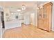 Charming dining area featuring hardwood floors, modern light fixture, and natural wood china cabinet at 2025 Sojourn Rd, Marshville, NC 28103