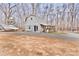 Side exterior view of a gray, two-story home with a boat parked on the side at 2025 Sojourn Rd, Marshville, NC 28103