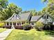 Inviting home featuring a covered porch and lush landscaping enhancing the property's curb appeal at 2025 Sojourn Rd, Marshville, NC 28103
