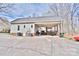 Rear exterior view showcasing the home's outdoor covered space and deck, with a concrete drive at 2025 Sojourn Rd, Marshville, NC 28103