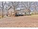 Rear exterior view showcasing the home's deck, patio, and covered outdoor space, surrounded by a wooded lot at 2025 Sojourn Rd, Marshville, NC 28103