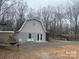 Exterior shot of garage with gray siding, double doors, and white decorative chairs at 2025 Sojourn Rd, Marshville, NC 28103