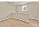 Hallway showcasing neutral paint, updated flooring and modern light fixture at 2025 Sojourn Rd, Marshville, NC 28103