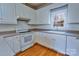 Functional kitchen with white appliances, tile backsplash, and hardwood flooring at 2025 Sojourn Rd, Marshville, NC 28103