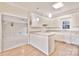 White kitchen with island, laminate countertops, modern appliances, and hardwood flooring at 2025 Sojourn Rd, Marshville, NC 28103