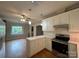 Bright kitchen features white cabinets, marble countertops, stainless steel appliances, and wood flooring at 2025 Sojourn Rd, Marshville, NC 28103