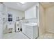 Laundry room featuring a sink, washer, dryer, and storage cabinets at 2025 Sojourn Rd, Marshville, NC 28103