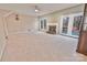 Spacious living room features neutral carpet, a fireplace, and French doors to the deck, creating a seamless indoor-outdoor flow at 2025 Sojourn Rd, Marshville, NC 28103