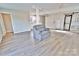 Open living room boasting updated flooring, neutral paint and lots of natural light at 2025 Sojourn Rd, Marshville, NC 28103