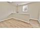 View of the loft area with new flooring, a window, and contemporary lighting at 2025 Sojourn Rd, Marshville, NC 28103