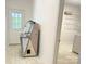 Mud room with exterior access and laundry, featuring a vintage jukebox and neutral tile flooring at 2025 Sojourn Rd, Marshville, NC 28103