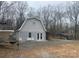 Outbuilding on the property featuring a barn-style roof, double doors, and additional parking and storage at 2025 Sojourn Rd, Marshville, NC 28103