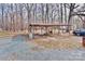 Open, covered parking area outside the home on a lot with gravel and fallen leaves at 2025 Sojourn Rd, Marshville, NC 28103