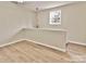 Bright room with modern floors, a window, and a unique chandelier at 2025 Sojourn Rd, Marshville, NC 28103