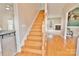 Inviting foyer features hardwood floors, a wooden staircase, and views into the living room with a fireplace at 2025 Sojourn Rd, Marshville, NC 28103