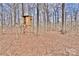 View of a treehouse structure surrounded by trees and fallen leaves at 2025 Sojourn Rd, Marshville, NC 28103