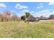 Spacious backyard with a wood fence, fire pit, green grass, and single-story home at 2211 Waverly St, Albemarle, NC 28001