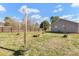 Spacious backyard with a wood fence, fire pit, green grass, and single-story home at 2211 Waverly St, Albemarle, NC 28001