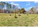 Spacious backyard with a wood fence, metal shed, green grass, and single-story home at 2211 Waverly St, Albemarle, NC 28001