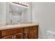 Bathroom with wood cabinets, granite countertops, and tiled floors at 2211 Waverly St, Albemarle, NC 28001