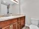 Bathroom with wooden cabinets, granite countertops, a framed mirror and white tile shower at 2211 Waverly St, Albemarle, NC 28001