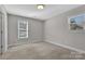 Comfortable bedroom with natural light from windows and neutral color scheme at 2211 Waverly St, Albemarle, NC 28001