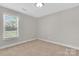 Compact bedroom with neutral carpeting, a window, and a closet at 2211 Waverly St, Albemarle, NC 28001