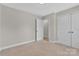 Bright bedroom with neutral carpet and ensuite bathroom access and closet at 2211 Waverly St, Albemarle, NC 28001