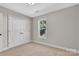 Bedroom featuring large closet doors, neutral carpet, and ample natural light at 2211 Waverly St, Albemarle, NC 28001