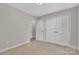 Bright bedroom with neutral carpet, double closet doors, and ensuite bathroom access at 2211 Waverly St, Albemarle, NC 28001