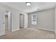 Bright bedroom with neutral carpet and ensuite bathroom access and closet at 2211 Waverly St, Albemarle, NC 28001