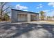 Garage with two bays and gravel driveway, perfect for storing your vehicles and other belongings at 2211 Waverly St, Albemarle, NC 28001