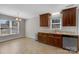 Corner kitchen with wood cabinets, marble countertops, and wood-look flooring at 2211 Waverly St, Albemarle, NC 28001